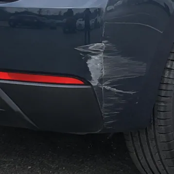 The same scrape on the rear bumper in the sample lot photo; a sample photo made with TunePixel AI.