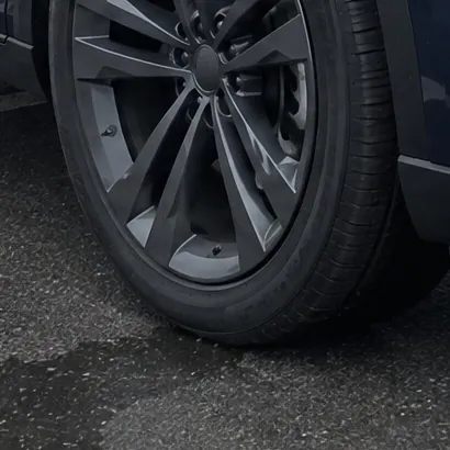 The same tyre on the wet car lot in the sample lot photo; a sample photo made with TunePixel AI.