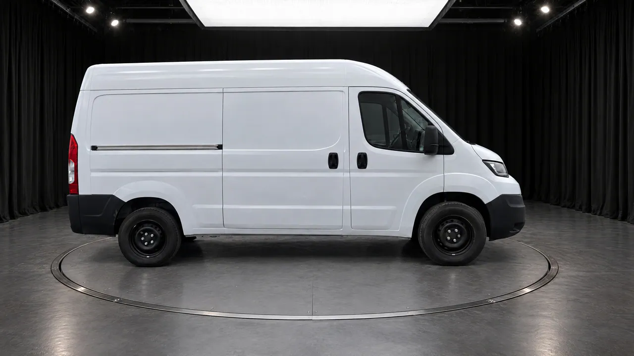 A fictional white panel van on a turntable in the Black Box studio, with black curtains and a grey floor, side view; made in TunePixel AI Studio.