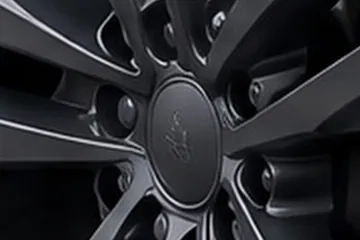 Close-up of the fictional SUV's front wheel in a Steel Hall render that was made again: a small emblem is drawn on the plain centre cap.